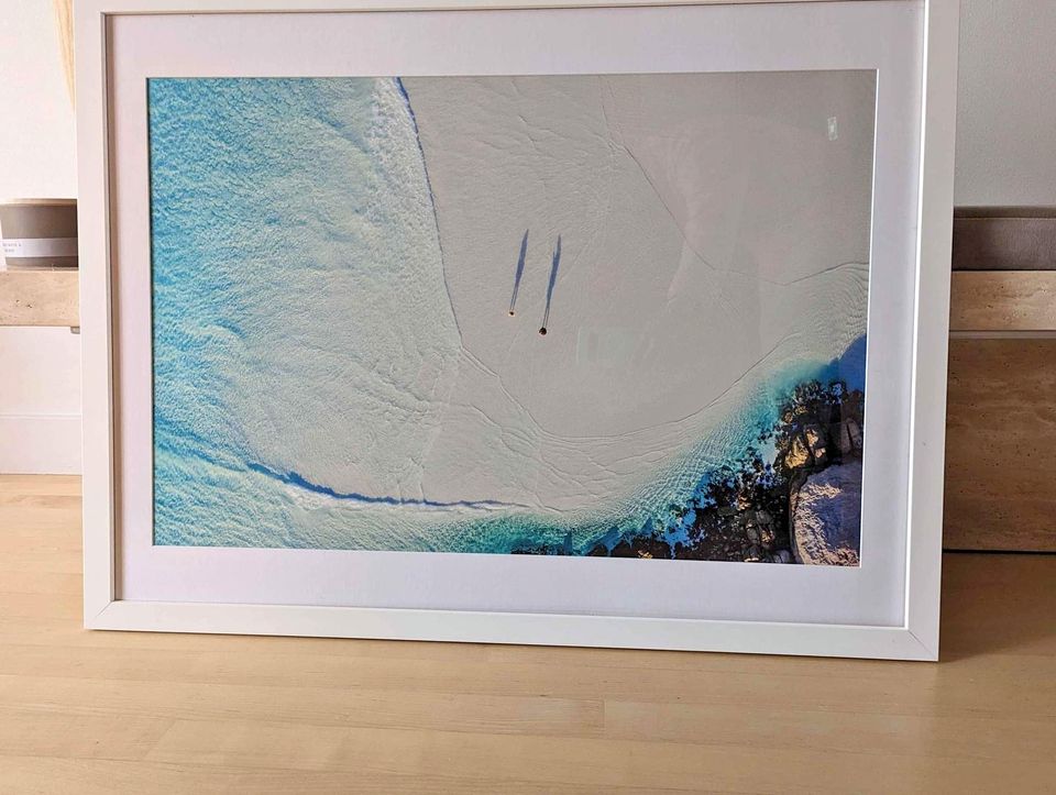 Aerial view of two people walking on the beach