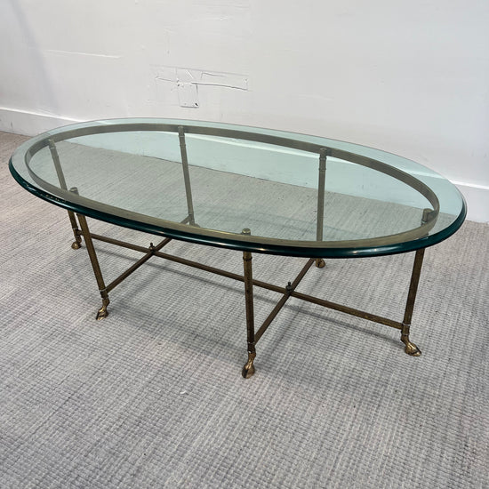 **MCM Brass oval glass coffee table by Labarge with brass hoof feet, 51ʺW × 26.5ʺD × 16.75ʺH